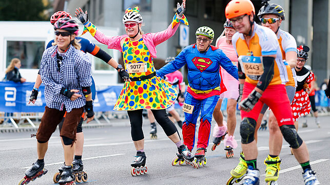 Skaters are with diverse costumes on the track
