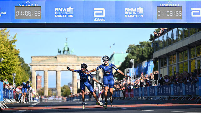 Two elite skaters cross the finish line